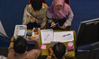 Job seekers conduct interviews at one of the company booths at the 2025 Job Fair at the Ke...