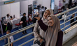 Job seekers take selfies in front of company booths at the 2025 Job Fair at the Ken Arok S...