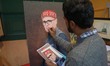 An artisan gives final touches to a portrait painting of Omar Abdullah, Chief Minister of...