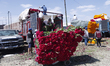 Vendors at the Central de Abasto market unload cempasuchil and terciopelo flowers from a t...