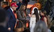 U.S. President Donald Trump and First Lady Melania Trump hand out candy to children during...