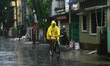 People are seen on their way during rain in Siliguri, India, on October 31, 2025. Continuo...
