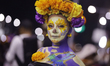 Women made up as skulls or Catrinas attend the opening of the International Day of the Dea...