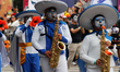 Persons take part in the 2025 Dia de Muertos Parade at Paseo de la Reforma Avenue during t...