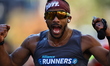 Runner John Johnson of the United States looks pumped after cooling himself down with wate...