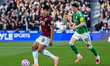 Mateus Fernandes (18 West Ham) shields the ball from Anthony Gordon (10 Newcastle) during...