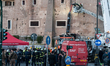 Firefighters work at the site after a section of the Torre dei Conti collapses near the Im...
