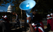 Demonstrators march to the U.S. Capitol building in Washington, D.C. on November 5, 2025 d...