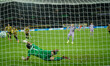 The ball hits the back of the net following Burke's successful penalty during the UEFA Con...