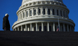 A person walks past the U.S. Capitol building in Washington, D.C. on November 6, 2025, as...