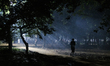 People walk through a park at night in Dhaka, Bangladesh, on November 7, 2025. 