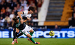 Giovani Lo Celso of Real Betis Balompie competes for the ball with Javi Guerra of Valencia...