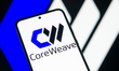 The CoreWeave logo is displayed on a mobile phone, with the company's branding visible in...