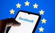 The Facebook logo appears on a smartphone screen, and the European Flag displays as the ba...