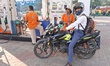A worker fills a motorcycle with petrol at a fuel station in Kolkata, India, on November 1...