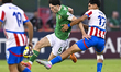 Rory Finneran of the Republic of Ireland and Thiago Vera of Paraguay are in action during...