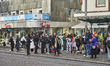 People wait for a tram next to carnival celebrations on Schillerplatz in Mainz, on novembe...