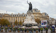 The monument at the Place de la Republique while people commemorate the victims of the ter...