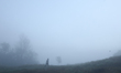 A Nepali man walks up the hill on a foggy winter morning in Lalitpur, Nepal, on November 1...