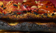 Burnt focaccia barese with tomatoes and olives emphasizes acrylamide and junk food health...