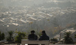 Two Iranian men sit together in a park in northwestern Tehran, Iran, on November 22, 2025,...
