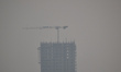 Workers work at a construction site on a smoggy day in Kolkata, India, on November 23, 202...