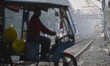 A suburban train moves towards a station on a smoggy day in Kolkata, India, on November 23...