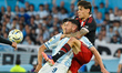 Adrian Martinez of Racing Club challenges for the ball with Martinez Quarta of River Plate...