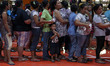 People wait to receive food packs during the solidarity dinner in Manila June 30, 2016. Ph...