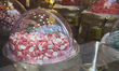 Colorful gummy candies, including marshmallow-style sweets, are displayed in the window of...