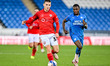 Jonathan Bland of Barnsley is challenged by Declan Frith of Peterborough United during the...