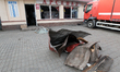 The fragments of the roof lie on the ground at a car shop damaged by a Russian drone strik...
