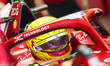 Lewis Hamilton of Great Britain and Scuderia Ferrari prepares to drive in the garage durin...