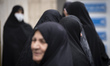 Veiled Iranian women gather outside a sports hall, waiting to participate in a celebration...