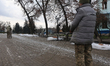 Men work on installing anti-drone nets on a street in Izium, Kharkiv region, Ukraine, on D...