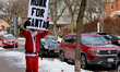 People in Santa suits run and walk through the Park Avenue and Monroe Avenue neighborhoods...