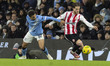 Rico Lewis #82 of Manchester City F.C. challenges the opponent during the Carabao Cup Quar...