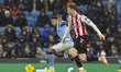Savinho #26 of Manchester City F.C. is challenged by Igor Thiago #9 of Brentford F.C. duri...