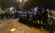 In Turin, Italy, on December 18, 2025, protesters clash with riot police during an evening...