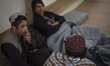 Afghan refugees sit in the Alghadir Refugee Camp located in the suburb of the border city...