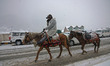 In Sonamarg, Jammu and Kashmir, India, on December 21, 2025, a man rides a horse amid heav...
