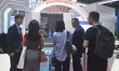 Visitors view the lithography machine models opened by Shanghai Microelectronics Equipment...