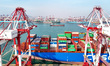 A giant cargo ship loads and unloads containers in the Qianwan Port Area of Qingdao Port i...