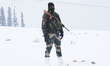 Central Reserve Police Force personnel keep vigil on a snow-covered slope at about 4,390 m...