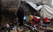 Palestinian displaced people inspect the damage to their temporary tents in Gaza City, Pal...