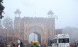 Commuters make their way amid fog on a winter morning in Jaipur, Rajasthan, India, on Janu...
