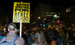 Demonstrators gather in Washington, D.C. on January 8, 2026 to protest the shooting and ki...