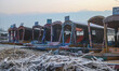Frost-covered boats moor to the banks of Dal Lake on a cold winter morning in Srinagar, Ja...