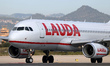 A Lauda Europe Airbus A320-232 prepares for takeoff on the Barcelona airport runway in Bar...