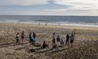 Several people relax on the sands of Carcavelos Beach in Lisbon, Portugal, on January 10,...